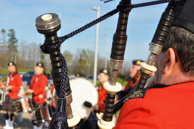 A bag piper plays in a procession